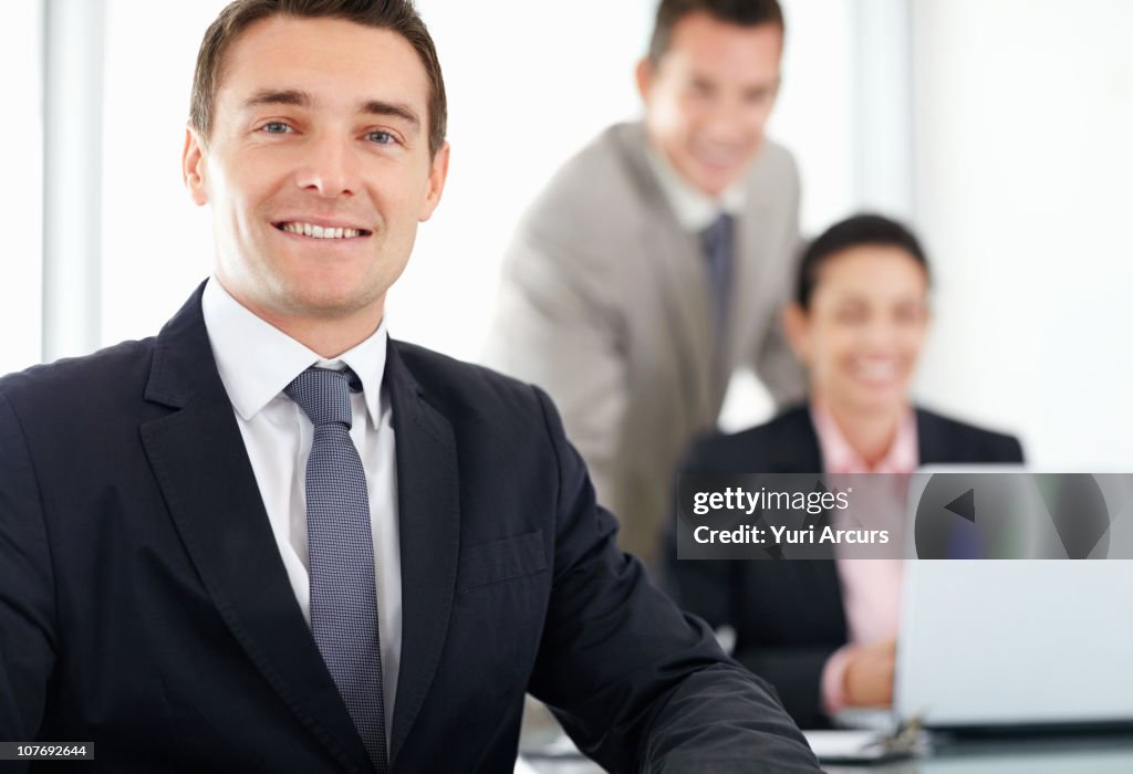 Businessman with colleagues in background