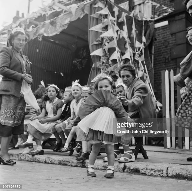 Every child wears a home-made costume at a party in Morpeth Street in London's East End, to celebrate the coronation of Queen Elizabeth II, June...
