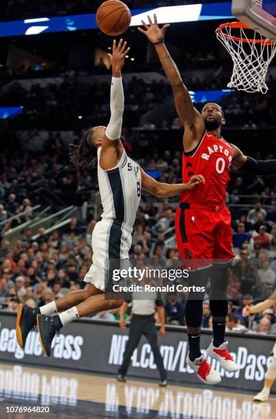 Miles of the Toronto Raptors blocks shot attempt of Patty Mills of the San Antonio Spurs at AT&T Center on January 3, 2019 in San Antonio, Texas....