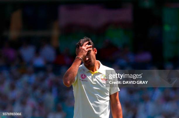 Australia's Mitchell Johnson reacts as he bowls during the second day of the fourth and final cricket Test between India and Australia at the Sydney...