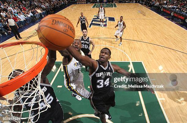 Antonio McDyess of the San Antonio Spurs goes to the net against Francisco Elson of the Utah Jazz during a game at EnergySolutions Arena on November...