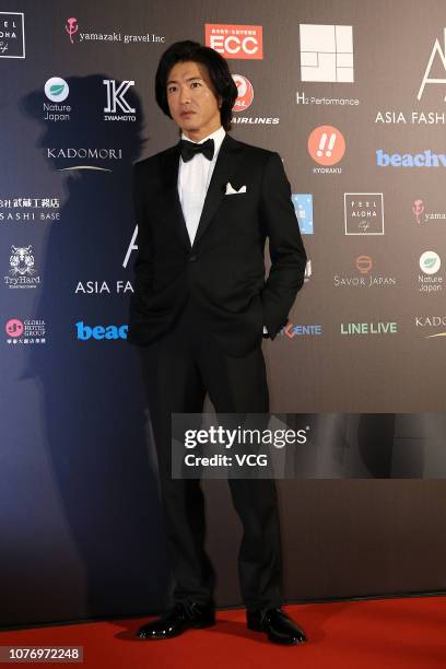 Japanese actor Takuya Kimura poses backstage during the Asia Fashion Award 2018 at Chiang Kai-sheak Memorial Hall on December 1, 2018 in Taipei,...