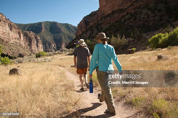couple hiking in canyon near green river - dinosaur national monument stock pictures, royalty-free photos & images