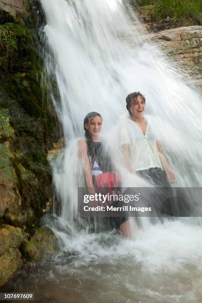 teenage girls under waterfall - dinosaur national monument stock pictures, royalty-free photos & images