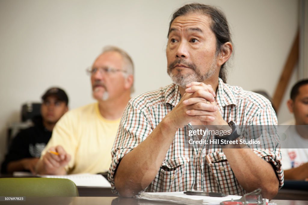 Adult students listening in classroom