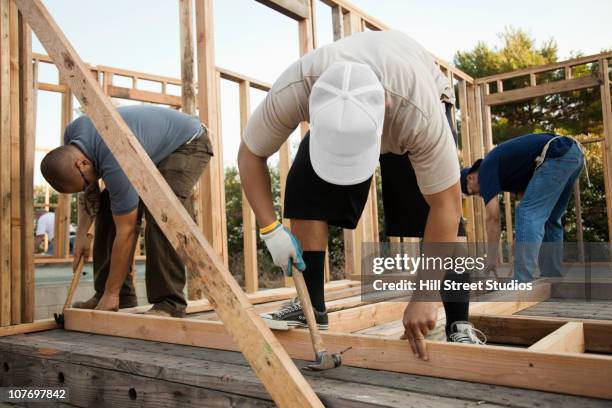 construction workers building house frame - three nails stock pictures, royalty-free photos & images