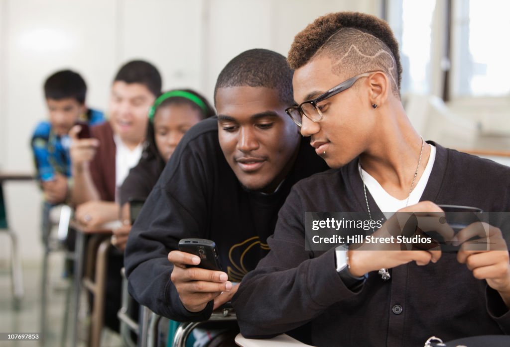 Students Using Phones In Class High School Students Using Cell Phones In Classroom High-Res Stock ...