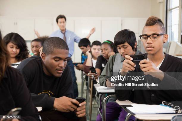 high school students using cell phones in classroom - blind spot stock pictures, royalty-free photos & images