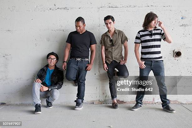 teenage boys leaning against wall - only teenage boys stock pictures, royalty-free photos & images