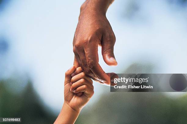 child holding adult's hand - kids hand stock pictures, royalty-free photos & images