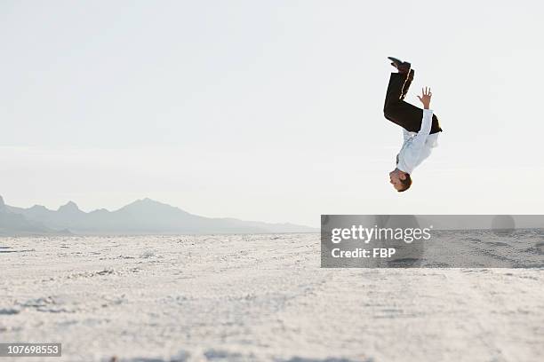 usa, utah, boneville salt flats, young man doing backflip in desert - backflipping stock pictures, royalty-free photos & images