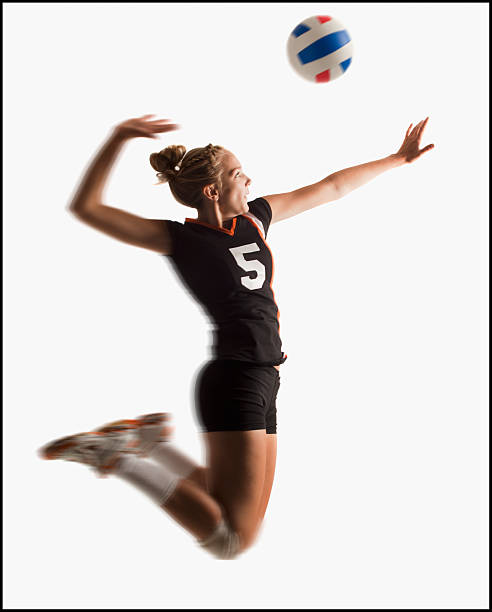 young girl (16-17) playing volleyball - girls volleyball stock pictures, royalty-free photos & images