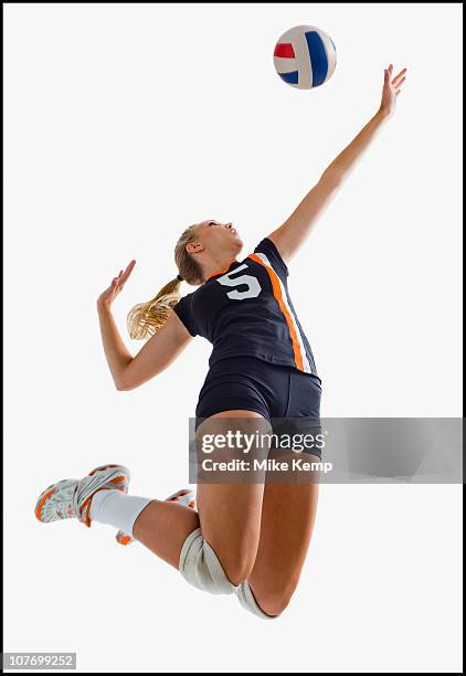 young girl (16-17) playing volleyball - volleyball stock-fotos und bilder