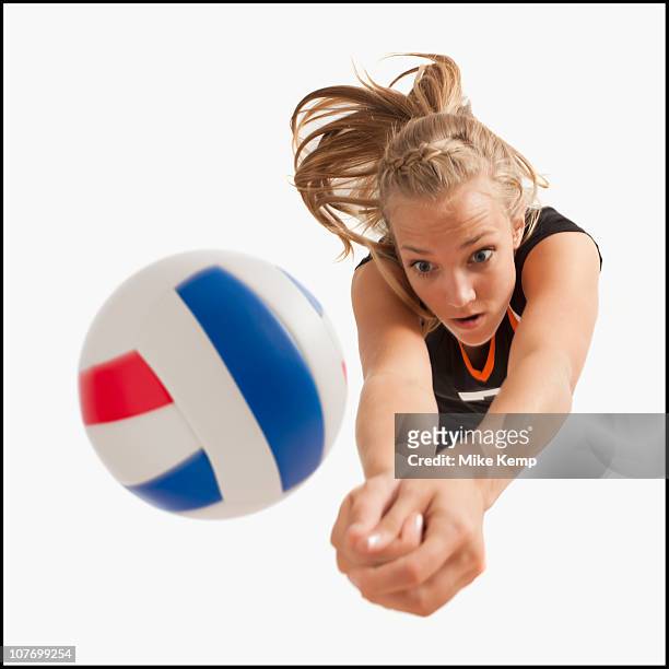 young girl (16-17) playing volleyball - spiking stock-fotos und bilder