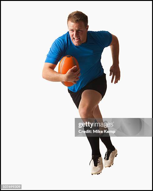 male rugby player running with ball - rugby player stock pictures, royalty-free photos & images