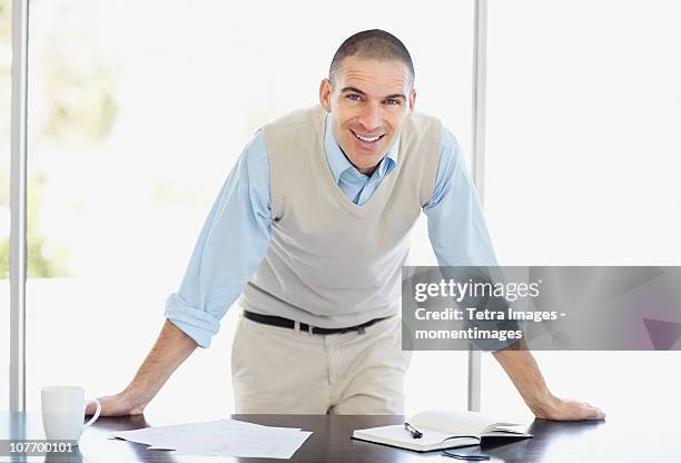 south africa, cheerful office worker with hands behind back - shaved head stock pictures, royalty-free photos & images
