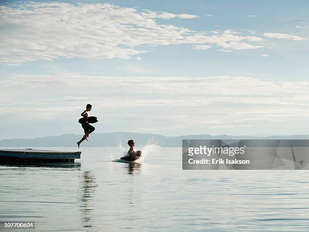 usa, utah, garden city, boys (10-11,12-13) jumping from raft - 11 loch stock pictures, royalty-free photos & images