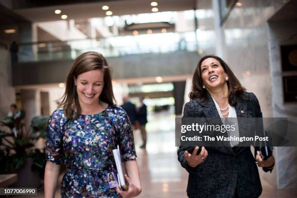 Senator Kamala Harris walks back to her Hart Senate Office Building office with communications director Lily Adams after casting votes concerning the...