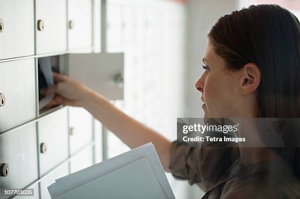 usa, new jersey, woman taking letters from mailbox - mailbox stock-fotos und bilder