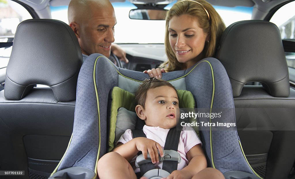 USA, New Jersey, Jersey City, Young family with small girl (12-18 months) sitting in car