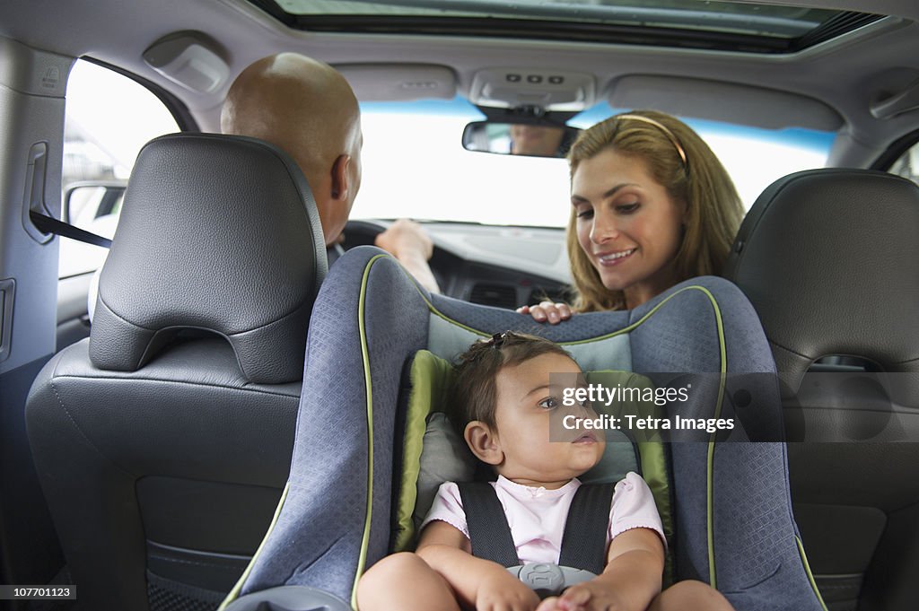 USA, New Jersey, Jersey City, Young family with small girl (12-18 months) sitting in car