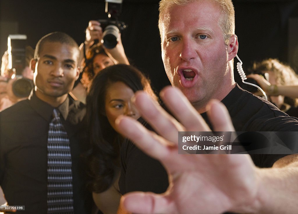 USA, New Jersey, Jersey City, Bouncer shielding celebrity at red carpet event