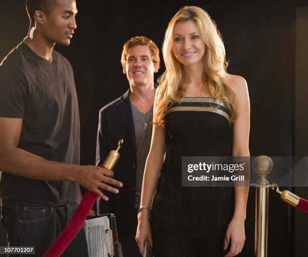 usa, new jersey, jersey city, woman passing bouncer outside club - traje a rigor imagens e fotografias de stock