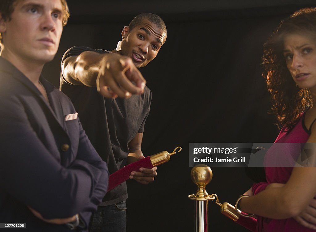 USA, New Jersey, Jersey City, Bouncer pointing outside club