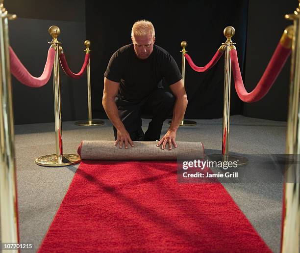 usa, new jersey, jersey city, bouncer rolling red carpet - roped off stock pictures, royalty-free photos & images