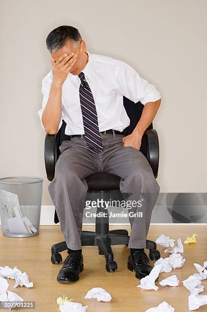 stressed businessman sitting in office - roll shirt stock pictures, royalty-free photos & images