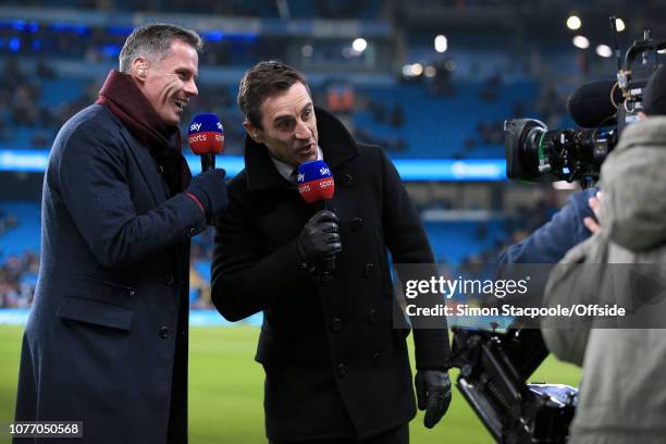 Sky Sports television pundits Jamie Carragher and Gary Neville joke in front of the camera during the Premier League match between Manchester City...