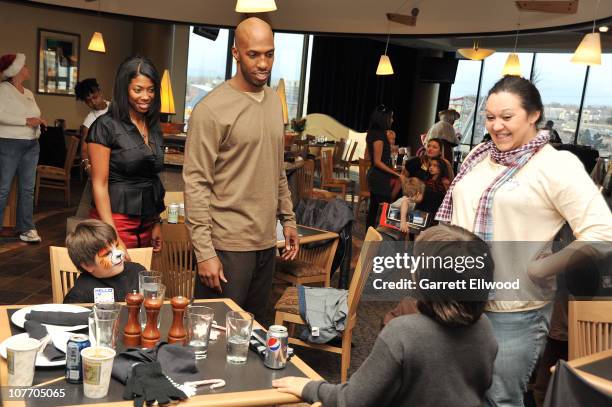 Chauncey Billups of the Denver Nuggets and his wife Piper Billups host thirty families from the Warren Village to a Holiday Party on December 20,...