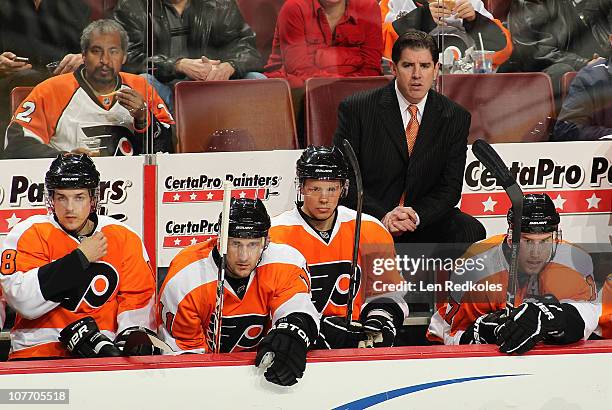 Danny Briere, Blair Betts, Darroll Powe, Jeff Carter and Head Coach Peter Laviolette of the Philadelphia Flyers watch the action during their game...
