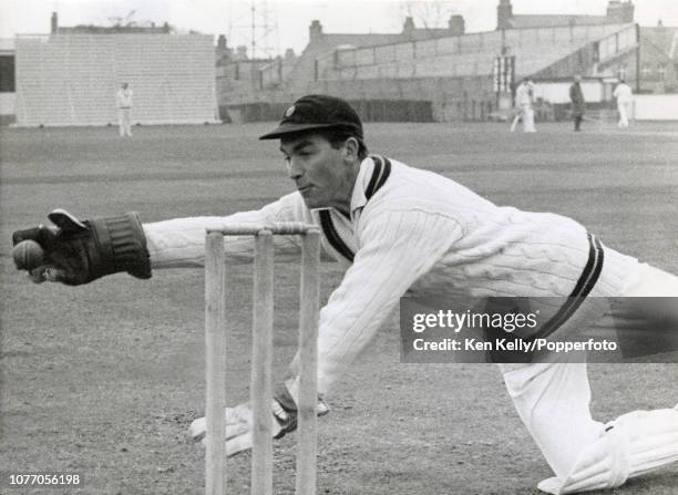 Northamptonshire wicketkeeper Keith Andrew poses for photos to illustrate his technique, at the County Ground in Northampton, circa 1960. Andrew...