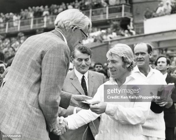 England cricketer Barry Wood is presented with his man of the match award by Prudential Assurance chairman Kenneth Usherwood after England won the...