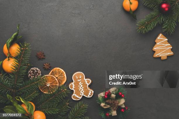 christmas background. fir tree, gingerbread cookies, tangerines - orange branch stock pictures, royalty-free photos & images