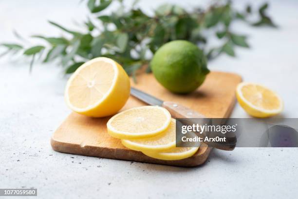 citrus slices on wooden board - lemon slice stock pictures, royalty-free photos & images