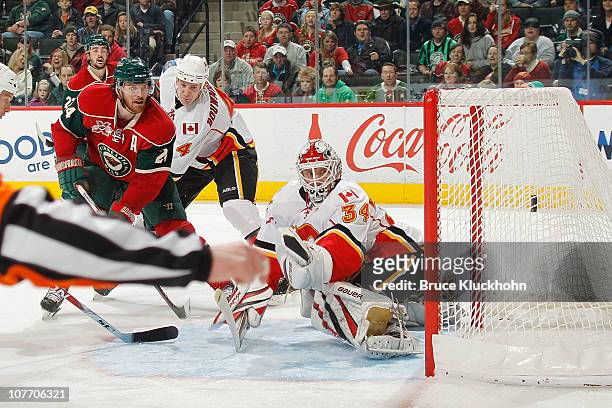 Martin Havlat of the Minnesota Wild scores a goal against Miikka Kiprusoff of the Calgary Flames during the game at the Xcel Energy Center on...