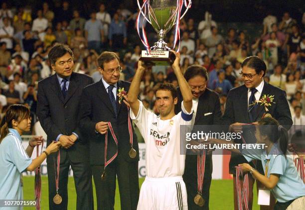 Spanish club Real Madrid captain Raul Gonzalez poses with the winner's trophy with Hong Kong and club officials, including Real president Florentino...