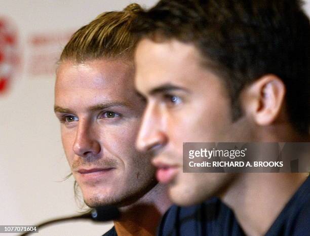 Spanish club Real Madrid player David Beckham of England looks on as team captain Raul Gonzalez of Spain answers a question during a press conference...