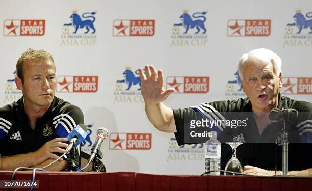 Newcastle captain Alan Shearer looks on while his team manager Sir Bobby Robson speaks during a press conference after arriving in Kuala Lumpur, 21...