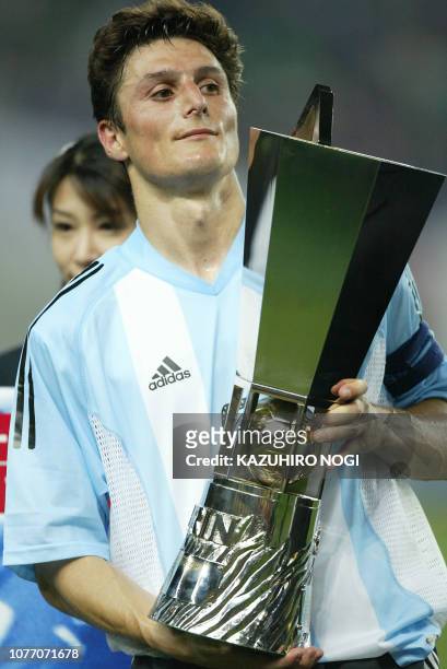 Argentine captain and defender Javier Zanetti holds the winner's trophy during an awarding ceremony at the Kirin Cup football against Japan at the...