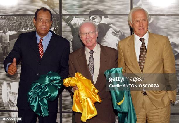 The ex captain Carlos Alberto Torres of the 1970 team and Luiz Bellini of the 1958 team pose next to Mario "Lobo" Zagallo, four time winner of the...