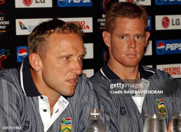 South Africa's star bolwer Allan Donald speak to reporters as captain Shaun Pollock looks on during a press conference in Colombo 24 September 2002....