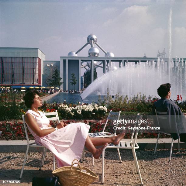 Sunbathing Before The French Flag And Atomium At The Exposition Universelle De Bruxelles On January 01St 1958.