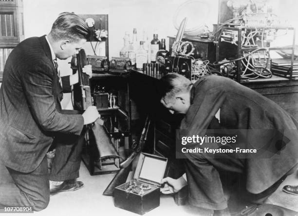 In The State Of New Jersey, Two Fbi Agents Examine The Arsenal Of Bootleggers They Just Stop In 1930