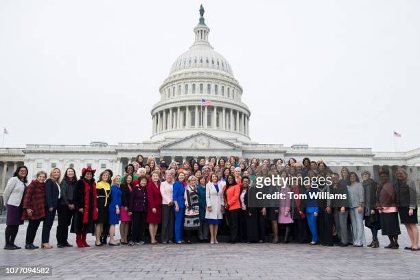 Speaker Nancy Pelosi, D-Calif., center, poses with Democratic women members of the House after a group photo on the East Front of the Capitol on...