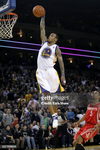 Monta Ellis of the Golden State Warriors dunks the ball over Courtney Lee of the Houston Rockets at Oracle Arena on December 20, 2010 in Oakland,...
