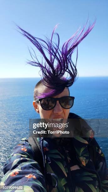 funny bad hair day - tossing hair facing camera woman outdoors stock pictures, royalty-free photos & images