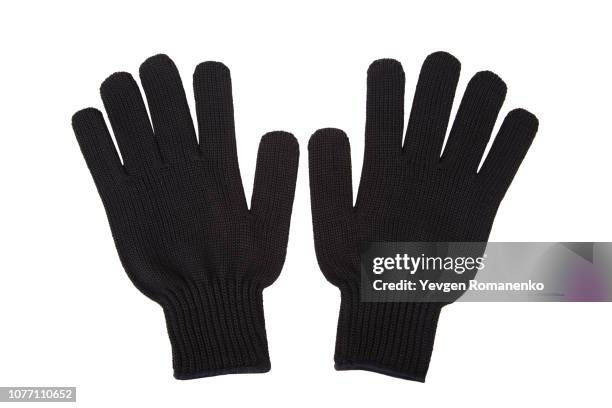 pair of black knit gloves isolated on white background - zwarte handschoen stockfoto's en -beelden
